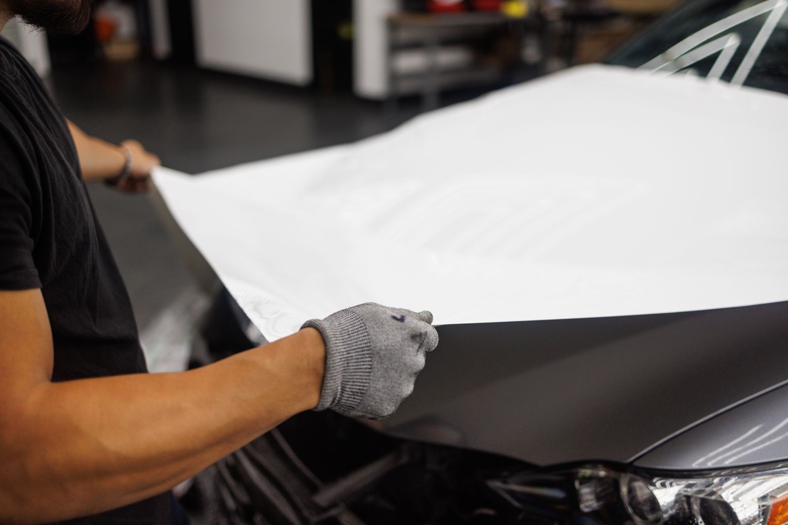 Film being laid over a car hood